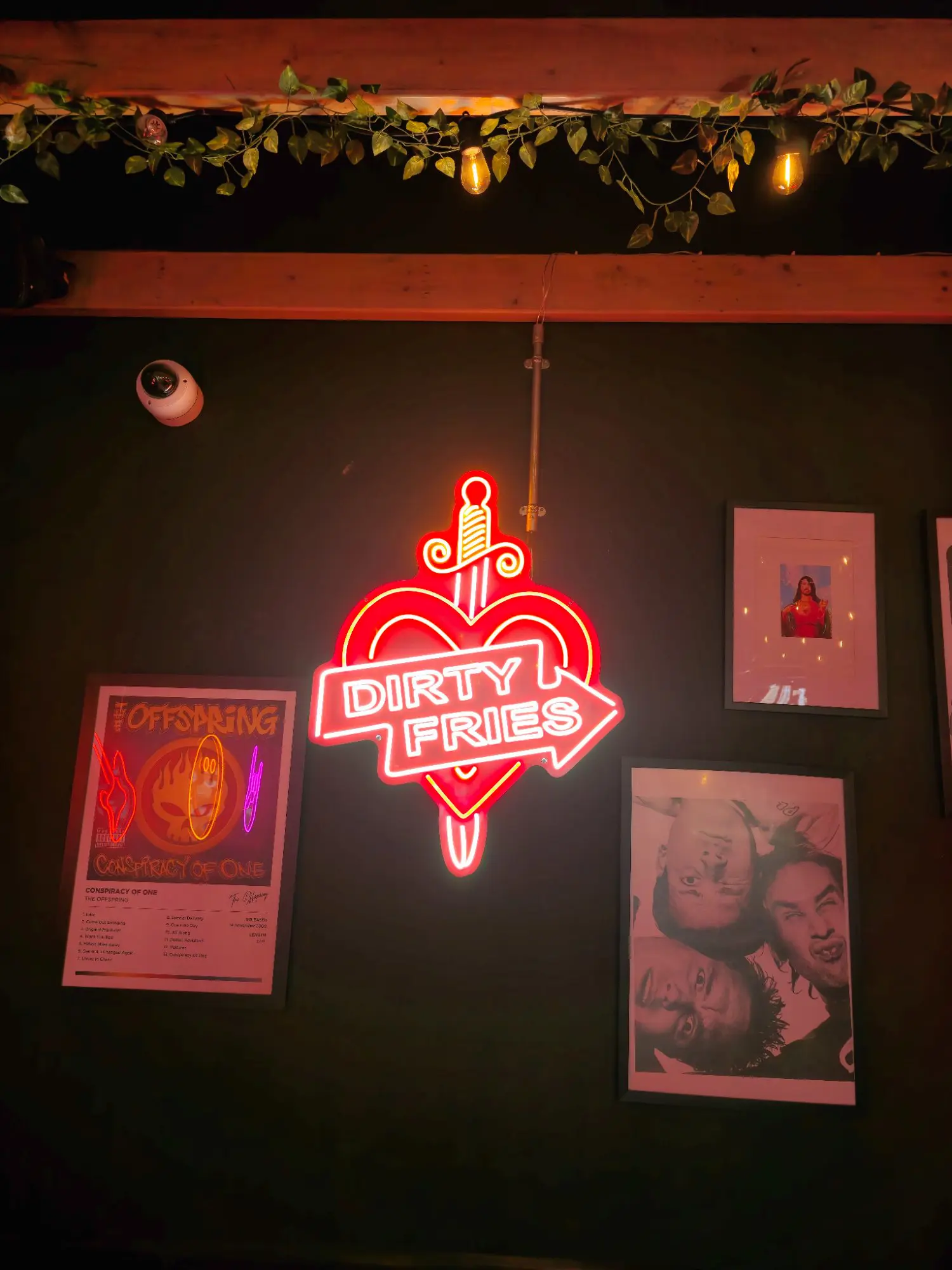 Dirty Fries neon sign with punk rock gig posters at Coyote Burger, Inverness